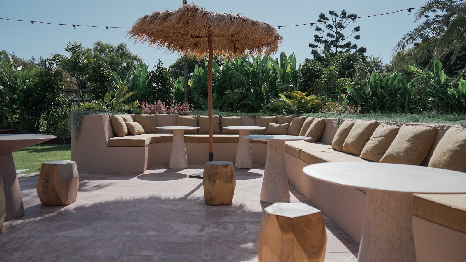 El banco del Swell terminado, con los cojines y el jardín tropical detrás